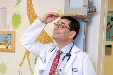 Geneticist Joel Hirschhorn measuring his height